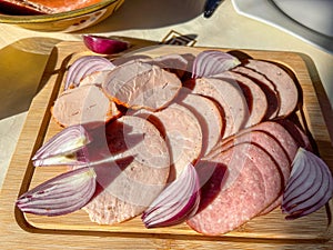 Rustic platter with salami, ham and onions