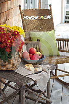 Rustic porch with apples and rocking chair