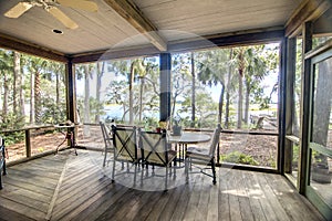 Rustic porch with forest and waterfront view