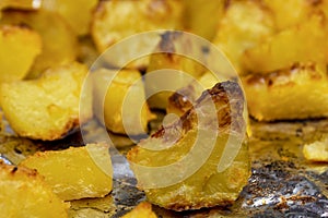 Rustic potatoes. Close-up, background of baked potatoes according to the old recipe. The concept of cooking, cooking, healthy and