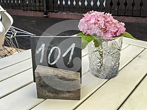 Rustic restaurant table with single hydrangea
