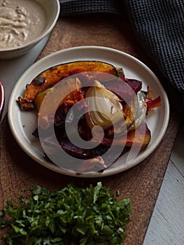 Rustic roast pumpkin slices on wooden board