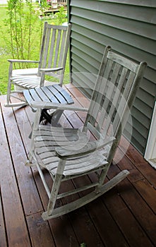 Rustic rocking chairs and table on wood porch