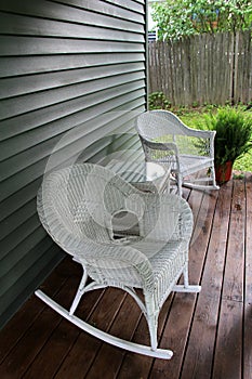 Rustic rocking chairs and table on wood porch