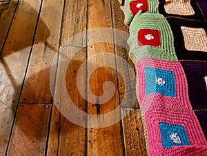 Rustic rug and chair shadow on wooden floorboards