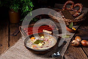 A rustic sauerkraut soup with bacon and sausage
