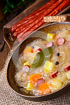 Rustic sauerkraut soup with bacon and sausage