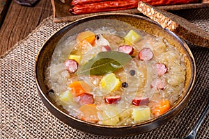 Rustic sauerkraut soup with bacon and sausage