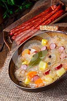Rustic sauerkraut soup with bacon and sausage