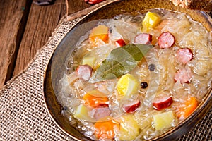Rustic sauerkraut soup with bacon and sausage