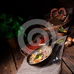 Rustic sauerkraut soup with bacon and sausage