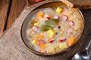 Rustic sauerkraut soup with bacon and sausage