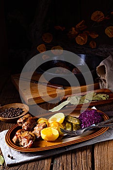 Rustic Snirtjebraten with red cabbage and cucumber photo