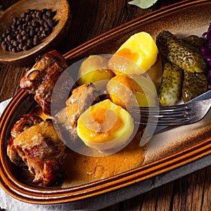Rustic Snirtjebraten with red cabbage and cucumber photo