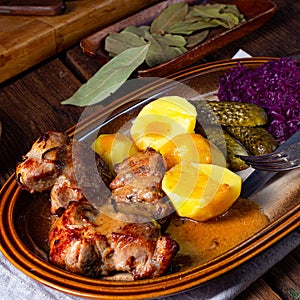 Rustic Snirtjebraten with red cabbage and cucumber photo