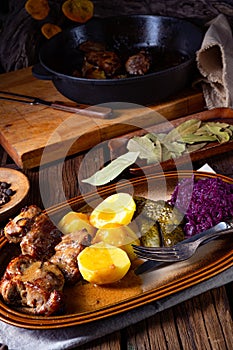 Rustic Snirtjebraten with red cabbage and cucumber photo