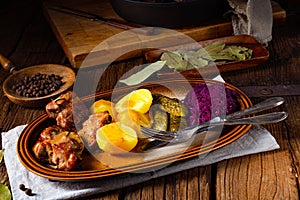 Rustic Snirtjebraten with red cabbage and cucumber photo