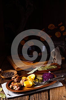 Rustic Snirtjebraten with red cabbage and cucumber photo