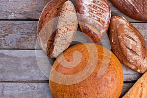 Rustic sourdough bread on wooden background.