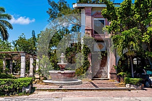 Rustic Spanish style residential bungalow and fountain