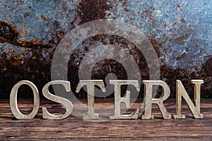 Rustic standing wooden letters with the inscription-Easter on a wooden background. Easter concept