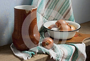 Rustic still life with jug, bowl, garlic and onion