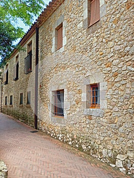 Rustic stone facade.. Pedestrian street in small village in the countryside. Rural tourism, architecture and constructions