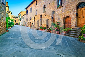 Rustic stone houses decorated with colorful flowers, Pienza, Tuscany, Italy