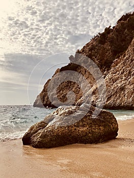 A rustic stone on KaputaÅŸ Beach invites beach dwellers