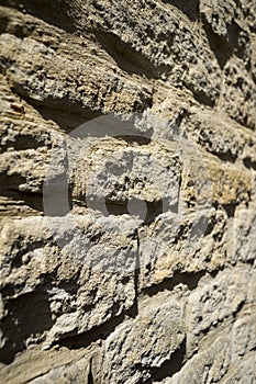 A rustic stone wall in the sunshine