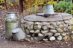 Rustic stone well, can and bucket