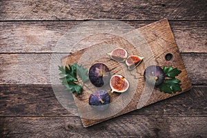 Rustic style Cut figs on chopping board and wooden table