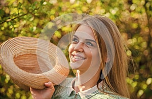 Rustic style. Romantic daydreamer hold summer hat. Rustic soul. Straw hat adorable girl. Rustic outfit. Ranch culture