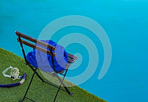 Rustic swimming pool back yard space with chair and snorkeling mask near blue water space simple background pattern