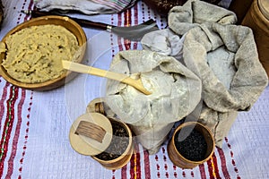 Rustic table with canvas bags with flour and cereals on white tablecloth embroidered