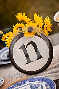 Rustic table setting with lettered plate.