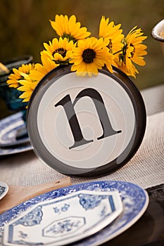 Rustic table setting with lettered plate.