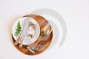 rustic table setting in natural forest style with wild ferns, wooden details and soft woodland tones.