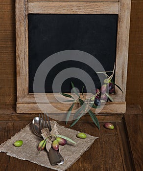 Rustic table setting with olive decor on old wooden table