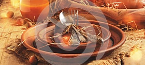 Rustic table setting for Thanksgiving Day: pottery, vintage appliances, straw, nuts and pumpkin. Old wooden background, banner