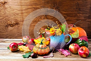 Rustic Thanksgiving arrangement with pumpkins and tagetes flower
