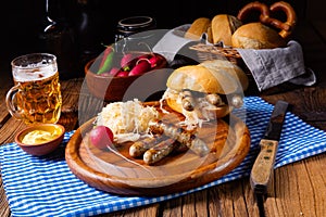 Rustic Thuringian bratwurst with sauerkraut and roll photo
