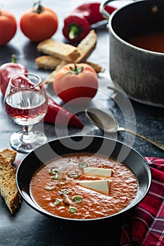 Tomato soup with white cheese in black bowl