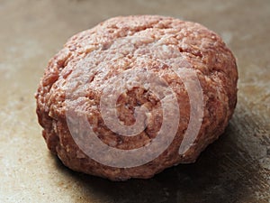 Rustic uncooked hamburger patty