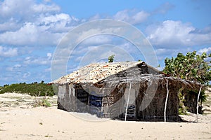 Rustic and very poor house on the beach. Poor fisherman`s house. Rustic wattle and daub and adobe construction