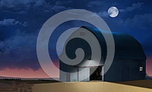 A rustic vintage farm barn is seen at night with a full moon above and roiling dark clouds across the sky