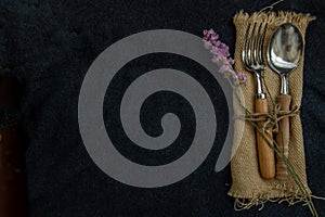 Rustic vintage set of wooden spoon and fork on black background