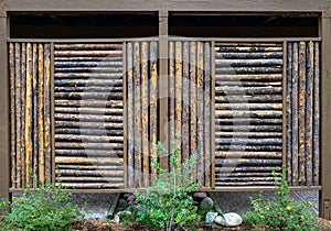 Rustic wall panel made out of small diameter wood logs, privacy screen