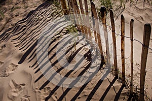 Rustic and weathered fence in front of sand dune on sandy sea beach Crosby England Europ