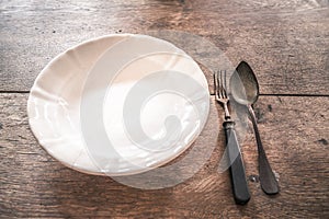 Rustic weathered tableware on wooden table